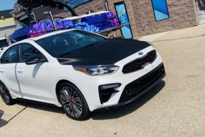 fancy cars in parking lot with wrap